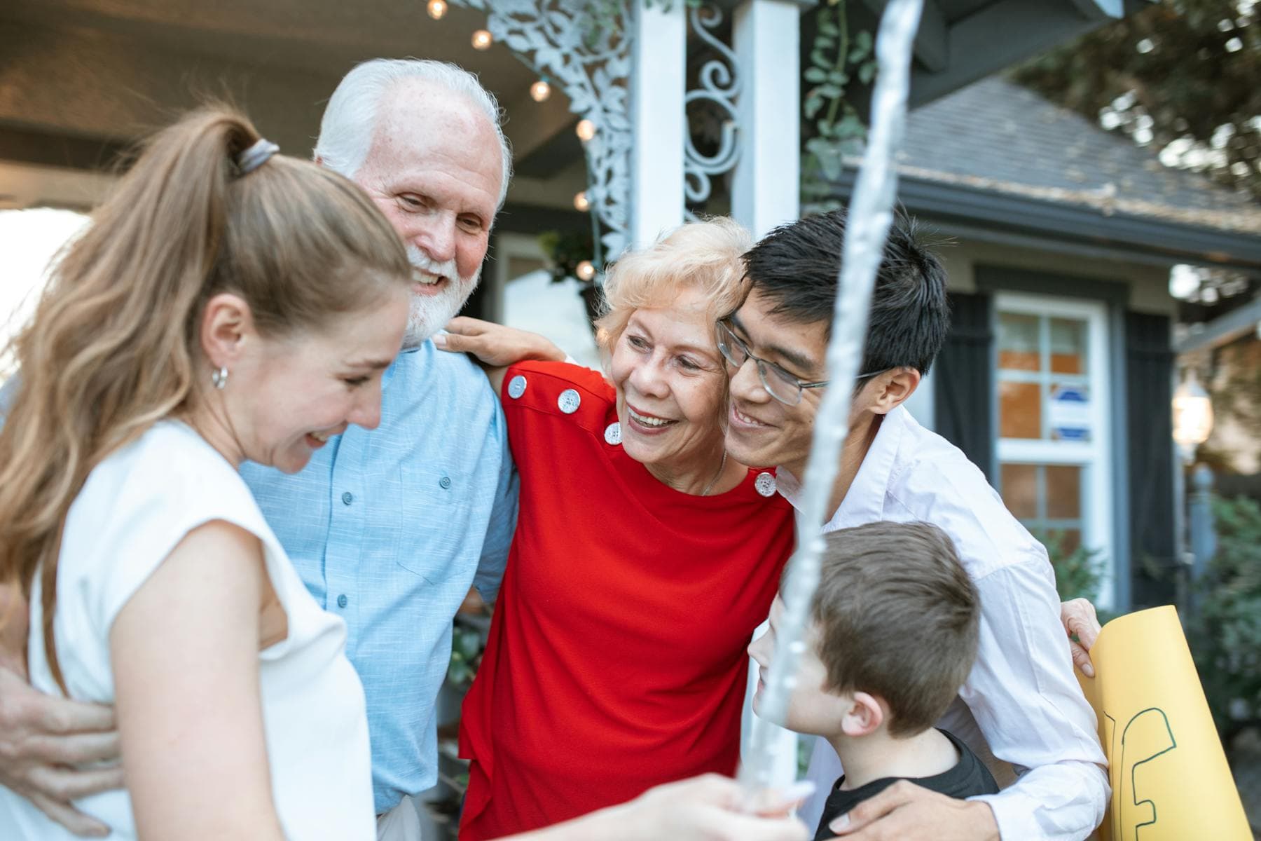 Multi-generational family embracing outdoors